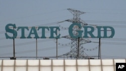 FILE - A State Grid sign is seen above a State Grid training center in Beijing.