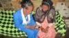  A community volunteer offers her neighbors cell phone access to request contraceptives in rural Ethiopia. (Photo Credit: Marie Stopes International, Ethiopia) 