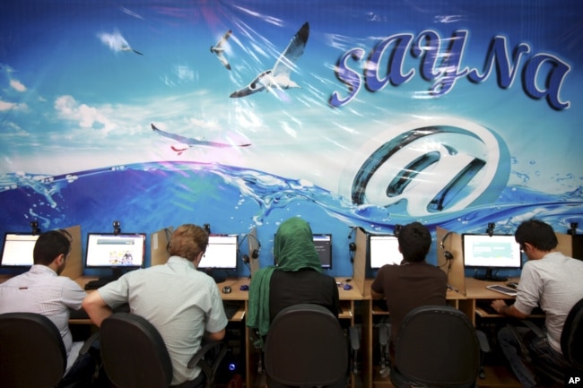 FILE - Iranians surf the internet at a cafe in Tehran.