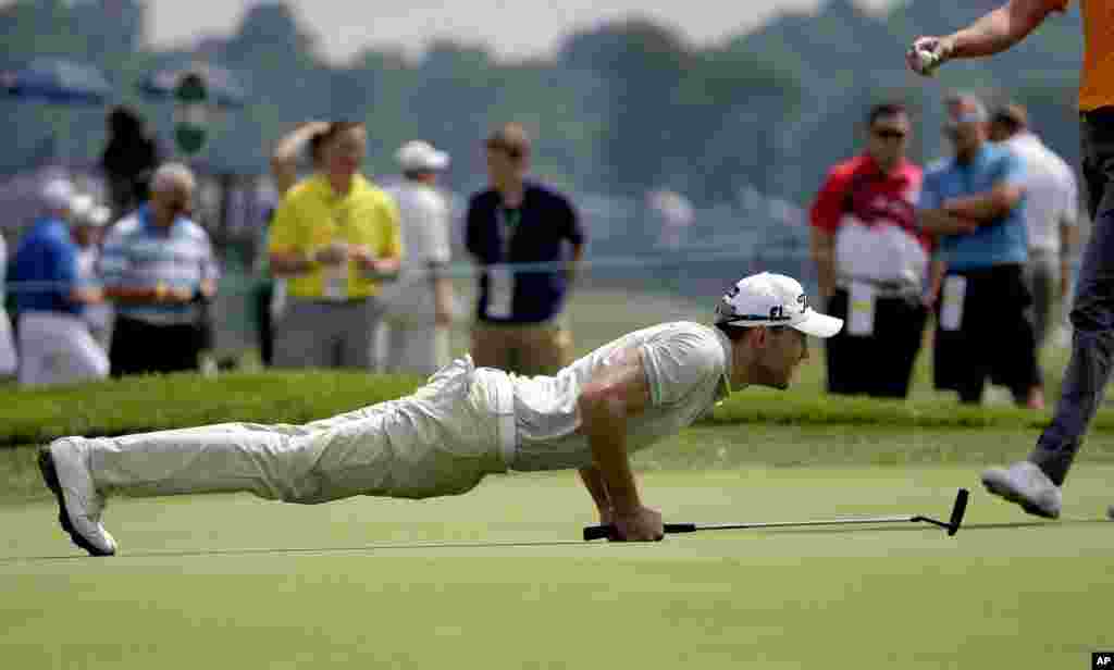 Max Kieffer, of Germany, lines up his putt on the 18th hole during the rain-delayed first round of the U.S. Open golf championship at Oakmont Country Club in Oakmont, Pennsylvania.