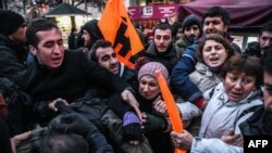 FILE - People scuffle as Turkish police detain protesters, Dec. 23, 2016, on Istiklal avenue in Istanbul, during a protest in reaction to a video released the previous day by the Islamic State group purportedly showing two captured Turkish soldiers being burned alive, and against the Turkish government's lack of immediate reaction. Turks reacted angrily on December 23 on social media to the video, while awaiting an official reaction from the government. The 19-minute video, showing two uniformed men being hauled from a cage before being bound and torched, was posted on jihadist websites and supposedly shot in the IS-declared "Aleppo Province" in northern Syria. 
