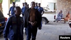 Polisi mengawal jenderal angkatan darat Burundi yang ditahan, Juvenal Niyungeko, ke pengadilan tinggi di Bujumbura, Burundi (16/5). (Reuters/Goran Tomasevic)