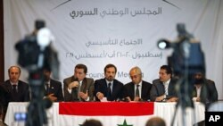 Members of Syrian oppositions (L-R) Ahmed Ramadan, Khaled Hassaleh, Hassan Hashmi, Lovay Safi, Abdul Basit Sida, Adip Shishakil, Hassan Shalabi attend a news conference after meeting in Istanbul, August 23, 2011