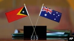 The flags of East Timor, left, and Australia are displayed during a ceremony at United Nations headquarters, March 6, 2018. 
