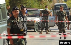 Lebanese army soldiers and policemen secure the area at the site where suicide bomb attacks took place in the Christian village of Qaa, in the Bekaa valley, June 27, 2016.