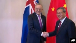 FILE - Australian Prime Minister Anthony Albanese shakes hands with Chinese Premier Li Qiang on the sidelines of summit talks in Vientiane, Laos, Oct. 10, 2024, in this image made from Australia Pool video.