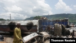 A man inspects the damage at the site of a gas tanker explosion in the central Nigerian state of Kogi, Sep. 23, 2020.