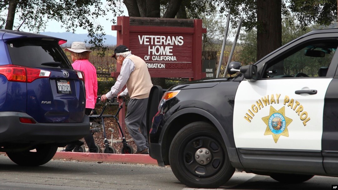 People walk to the information center at the Veterans Home of California in Yountville, Calif., March 9, 2018. A gunman took at least three people hostage at the largest veterans home in the United States on Friday, leading to a lockdown of the sprawling grounds in California, authorities said. 