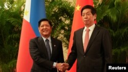 Philippines President Ferdinand "Bongbong" Marcos Jr., shakes hands with China's National People's Congress (NPC) Standing Committee Chairman Li Zhanshu at the Great Hall of the People in Beijing, China, Jan. 4, 2023. 