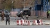 Security forces inspect the site of a deadly blast in the center of Kabul, Afghanistan, Nov. 12, 2018.