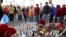 People pray at a makeshift memorial to honor the victims of Wednesday's shooting rampage, Dec. 5, 2015, in San Bernardino, Calif. 