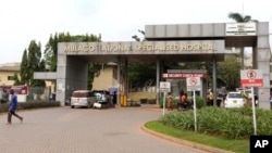 People walk outside the Mulago National Specialised Hospital in Kampala, Uganda, Jan, 30, 2024, where a nurse had died of Ebola.