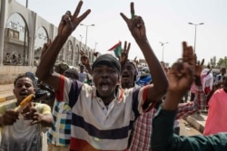 A group of protesters chant revolutionary slogans against military rule at the sit-in outside the military headquarters, in Khartoum, Sudan, Thursday, May 2, 2019.