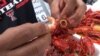 Removing the crawfish tail — it's the best part to eat. (G. Flakus/VOA)