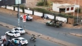 FILE: Members of the Rapid Support Forces [RSF], a paramilitary force now in conflict with the Sudanese army, block roads in Khartoum, Sudan, on Tuesday, Jan. 14, 2020.