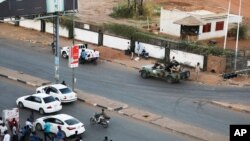 FILE: Members of the Rapid Support Forces [RSF], a paramilitary force now in conflict with the Sudanese army, block roads in Khartoum, Sudan, on Tuesday, Jan. 14, 2020.