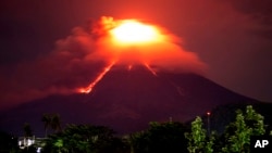 Lava cascades down the slopes of Mayon volcano as seen from Legazpi city, Albay province, around 340 kilometers (210 miles) southeast of Manila, Philippines, Jan. 15, 2018.