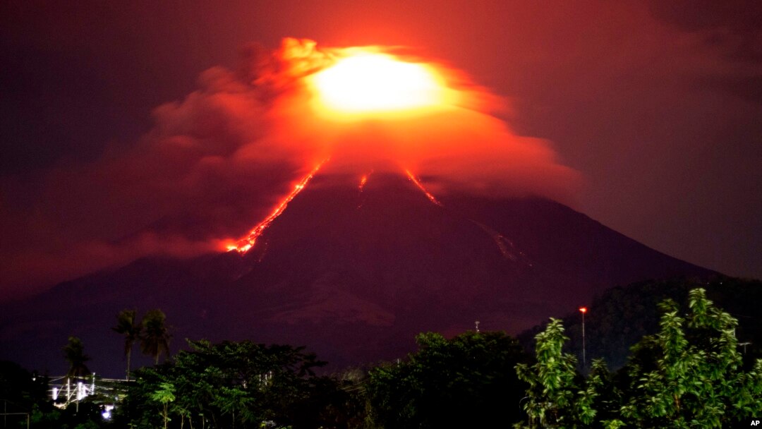 Lava cascades down the slopes of Mayon volcano as seen from Legazpi city, Albay province, around 340 kilometers (210 miles) southeast of Manila, Philippines, Monday, Jan. 15, 2018. 