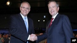 Australian Prime Minister Scott Morrison, left, and opposition leader Bill Shorten shake hands before the Sky News/Courier Mail People's Forum in Brisbane, May 3, 2019. 