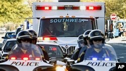 Tucson police escort the ambulance of U.S. Rep. Gabrielle Giffords, as she is being moved to Memorial Hermann Hospital in Houston for rehabilitation, 21 Jan 2011