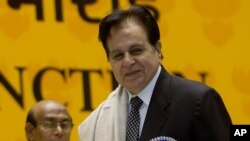 FILE - In this Sept. 2, 2008, photo, veteran Bollywood actor Dilip Kumar, right, receives a Lifetime Achievement award at the 54th National Film Award ceremony in New Delhi, India.