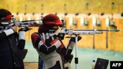 FILE - Shimaa Hashad of Egypt takes part in a pratice session with an air rifle at the International Shooting Sport Federation (ISSF) World Cup at Dr. Karni Singh Shooting Range, in New Delhi, Feb. 20, 2019.