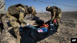 Des soldats égyptiens collectent les effets personnels des passagers morts dans le vol russe écrasé dans le Sinaï. (Russian Ministry for Emergency Situations photo via AP)