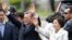 FILE - South Korea's new President Moon Jae-in waves to neighborhoods and supporters with his wife Kim Jung-sook upon their arrival outside the presidential Blue House in Seoul, South Korea, May 10, 2017.