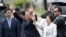 South Korea's new President Moon Jae-in waves to neighborhoods and supporters with his wife Kim Jung-sook upon their arrival outside the presidential Blue House in Seoul, South Korea, May 10, 2017.