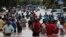Residents wade through a flooded road in the aftermath of Hurricane Eta in Planeta, Honduras, Nov. 5, 2020. 