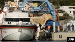 A group of migrants embark on an Italian ship at Shengjin port in Albania on Oct. 19, 2024. The 12 migrants left Albania for Italy after judges ruled against their detention in the non-EU nation under a controversial deal between Rome and Tirana.