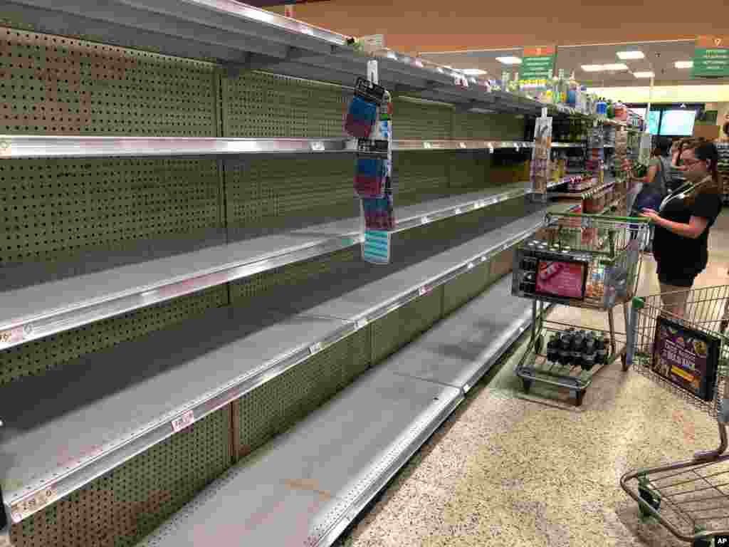 Store shelves are empty of bottled water as residents buy supplies in preparation for Hurricane Dorian, in Doral, Florida. The U.S. National Hurricane Center says Dorian could hit the Florida coast over the weekend as a major hurricane.