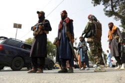 FILE - Taliban fighters patrol in the Wazir Akbar Khan neighborhood in Kabul, Afghanistan, Aug. 18, 2021. The day before, the Taliban declared an "amnesty" across Afghanistan and urged women to join their government.