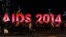 People gather next to a sign reading AIDS 2014 in Melbourne on July 18, 2014 after news that downed Malaysia Airlines flight MH17 was carrying many participants headed to the 20th International AIDS Conference planned this weekend in the Australian city. 