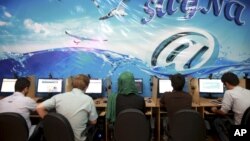 Iranians surf the internet at a cafe in Tehran, Iran, Sept, 17, 2013. In Iran, a government push for a 'halal' internet means more control after protests.