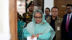 Mantan Perdana Menteri Bangladesh Sheikh Hasina tampak memeriksa jam tangannya saat menunggu giliran untuk menggunakan hak pilihnya di salah satu tempat pemungutan suara di Dhaka, Bangladesh, pada 7 Januari 2024. (Foto: AP/Altaf Qadri)