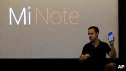 Xiaomi vice president of global operations Hugo Barra holds up a Mi Note during a presentation in San Francisco, Thursday, Feb. 12, 2015. 