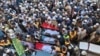 People attend the funeral prayers for the victims of the previous day's suicide bombing in Bannu, northwestern Pakistan, March 5, 2025. 