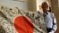 WWII veteran Marvin Strombo holds up a Japanese flag with names written on it in Portland, Ore., Monday, Aug. 7, 2017. 