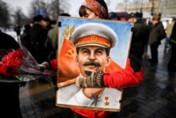 FILE - Russian Communist Party supporters attend a memorial ceremony to mark the 65th anniversary of Soviet leader Josef Stalin's death, on Red Square in Moscow, March 5, 2018.