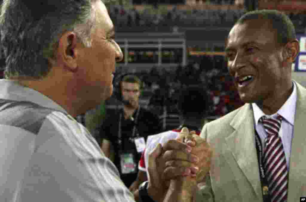 Equatorial Guinea's head coach Gilson Paulo (L) of Brazil shakes hands with Libya's head coach Marcos Paqueta of Brazil before their teams' opening match at the African Nations Cup soccer tournament in Estadio de Bata "Bata Stadium", in Bata January 21, 2