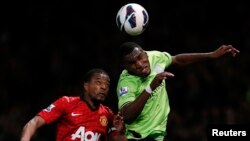 Manchester United's Patrice Evra (L) challenges Aston Villa's Christian Benteke during their English Premier League soccer match at Old Trafford in Manchester, northern England, April 22, 2013.