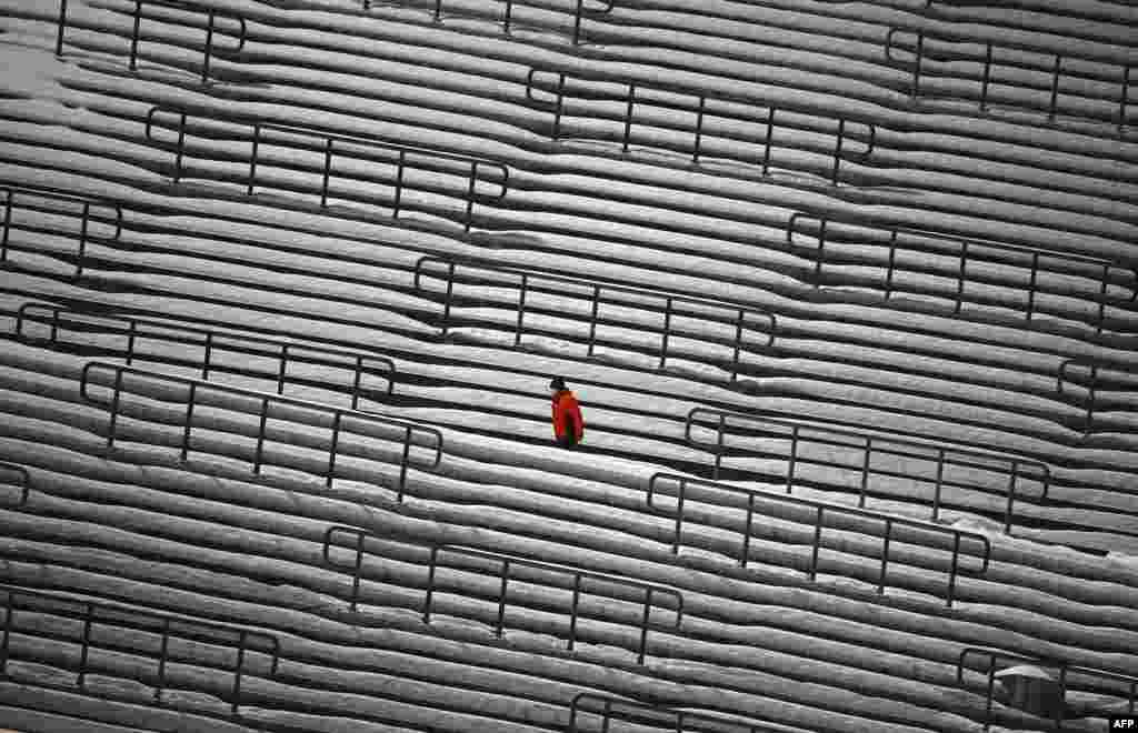 A ski jump staff member walks at empty stands during the second competition jump of the FIS Men&#39;s Ski Jumping World Cup in Willingen, western Germany, Jan. 30, 2021.