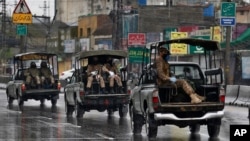 FILE - Pakistani troops patrol during a coronavirus lockdown in Rawalpindi, Pakistan, March 24, 2020. The government announced soldiers will again enforce public safety restrictions to contain the pandemic.