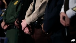 Law enforcement officers stand on stage during a security news conference in advance of the Super Bowl 52 football game, Wednesday, Jan. 31, 2018, in Minneapolis. The Philadelphia Eagles play the New England Patriots on Sunday, Feb. 4, 2018.