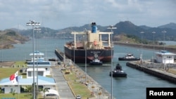 FILE - Cargo vessels transit through the Panama Canal, on the outskirts of Panama City on April 19, 2023.