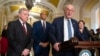 FILE - Senate Majority Leader Chuck Schumer of New York speaks with reporters as, from left, Sen. Dick Durbin, Sen. Cory Booker, and Sen. Amy Klobuchar, listen on Capitol Hill, Dec. 3, 2024, in Washington. 