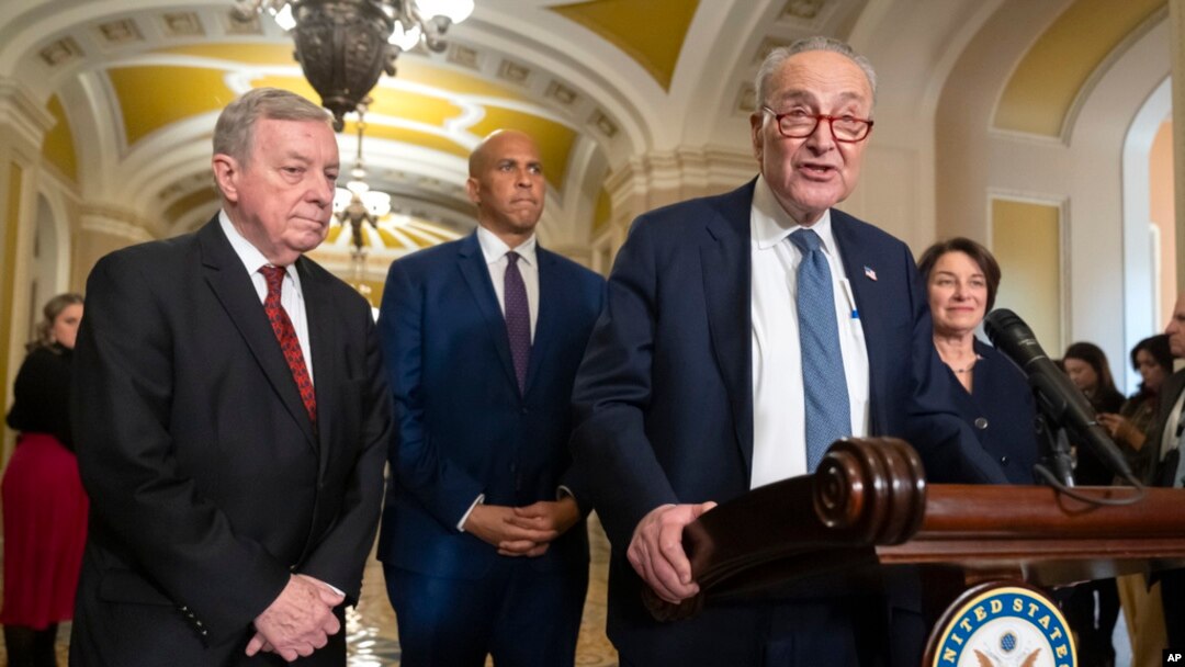FILE - Senate Majority Leader Chuck Schumer of New York speaks with reporters as, from left, Sen. Dick Durbin, Sen. Cory Booker, and Sen. Amy Klobuchar, listen on Capitol Hill, Dec. 3, 2024, in Washington.