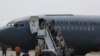 Relatives of passengers of a missing military plane arrive in a Chilean military airplane to an airbase in Punta Arenas, Chile, Dec. 11, 2019. 