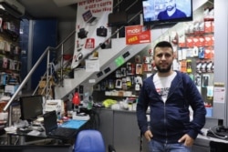 Malak, 27, lost 20 percent of his salary when the Lebanese dollar crisis began while his colleague lost his job entirely, in Beirut, Nov. 21, 2019. (Heather Murdock/VOA)